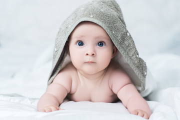 Baby girl or boy after shower with towel on head © IrBreeze