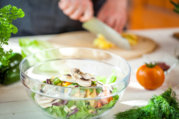 Chef cutting fresh and delicious vegetables for salad