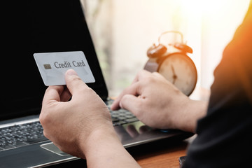 Close up hand holding credit card for online payment, online payment concept.