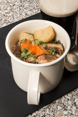 dublin coddle in a mug on slate
