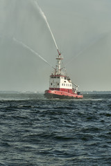 Fireboat, pumps a stream of water - shows for watchers