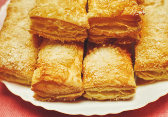Puff pastry cakes with sugar powder close up
