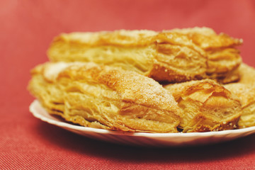 Puff pastry cakes with sugar powder close up