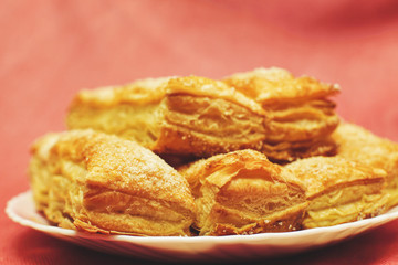 Puff pastry cakes with sugar powder close up