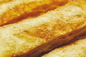 Puff pastry cakes with sugar powder close up