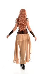 full length portrait of a red haired lady, wearing a steampunk inspired outfit, isolated  on white background.