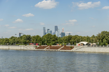 Fototapeta premium View of riverside of Moscow river and Moscow city skyscrapers behind the trees