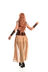 full length portrait of a red haired lady, wearing a steampunk inspired outfit, isolated  on white background.