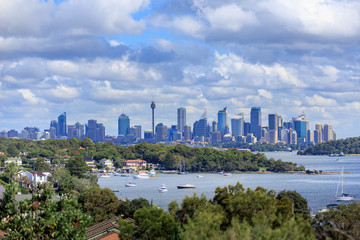 A view of Watsons Bay and the distant skycrapers of Sydney' CBD, Water with Yacht, Harbour Bridge...