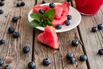 Watermelon juice on a wooden table. It can be used as a background