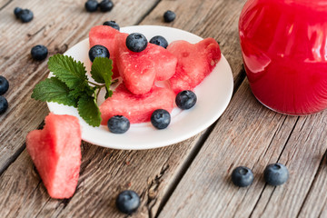 Watermelon juice on a wooden table. It can be used as a background