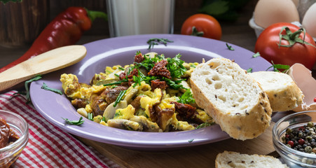 Scrambled egg with dried tomatoes and home baked goods