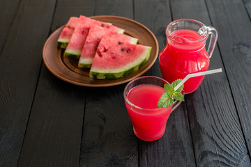 Watermelon juice on a wooden table. It can be used as a background