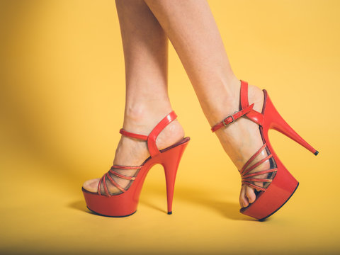 Woman in red stripper heels on yellow