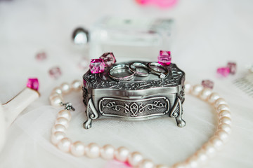 wedding ring on a cassette decrate with pink gems