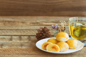 Chinese pastry with sweet mung bean and salted egg. Moon cake or Chinese pastry filled with mung bean paste and salted egg served with green tea. Delicious homemade Chinese pastry ready to served.