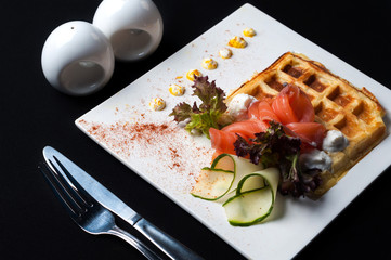 fish salmon salad on a white plate with sauce
