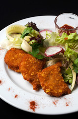 snack to beer on a large wooden plate with the sauce
