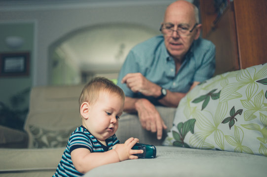 Grandfather playing with baby grandson