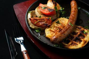juicy sausage grill on a beautiful pan with vegetables
