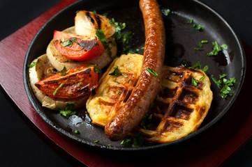juicy sausage grill on a beautiful pan with vegetables
