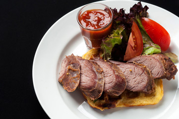 Pork steak with vegetables and garnish
