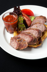Pork steak with vegetables and garnish
