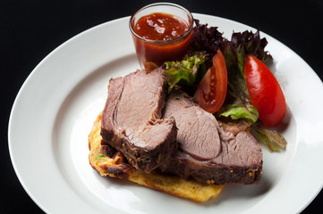 Pork steak with vegetables and garnish
