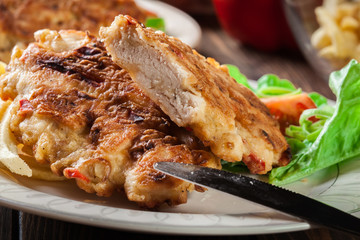 Chicken medallions with red peppers served with chips