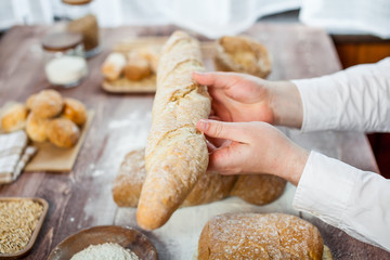 Baker man holding a beautiful fresh bread