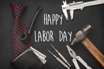 happy labor day text sign concept flat lay. working tools, bow tie leather wallet with money wooden...