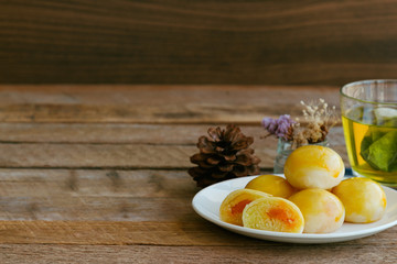 Chinese pastry with sweet mung bean and salted egg. Moon cake or Chinese pastry filled with mung bean paste and salted egg served with green tea. Delicious homemade Chinese pastry ready to served.