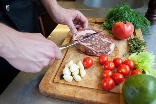 chef prepares beef meat.