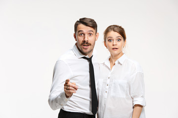 Successful business couple at the office looking at camera