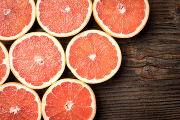 Red grapefruits on an old wooden table
