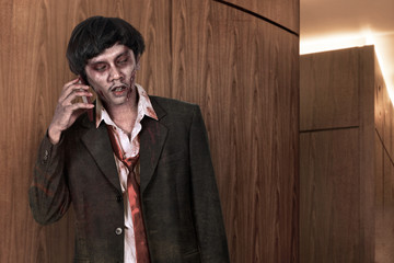 Creepy asian zombie man in suit call via cellphone