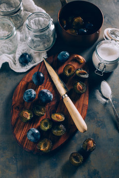 Overhead view of chopped plums on cutting board