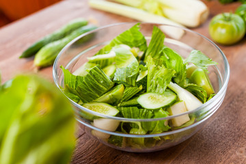 vegetable green salad bowl on kitchen table, balanced diet