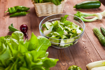 vegetable green salad bowl on kitchen table, balanced diet