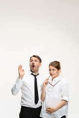 Successful business couple at the office looking up