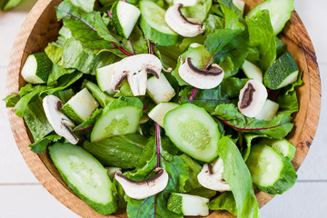 vegetable green salad bowl on kitchen table, balanced diet