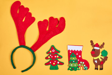 Flat lay of Christmas decoration on yeallow background