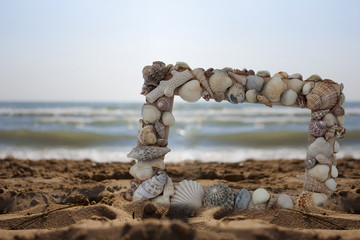 Fototapeta premium Bilderrahmen aus Muscheln am Strand