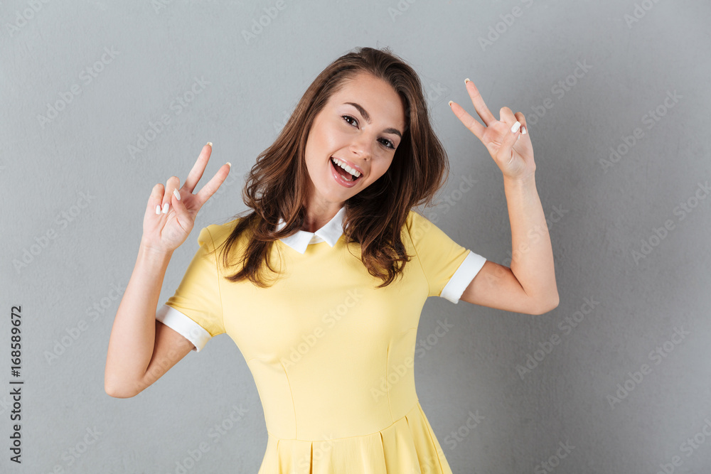 Sticker happy girl in dress showing peace gesture with two hands