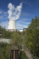 Thermoelectric power station with smoke pipe on the background of blue sky