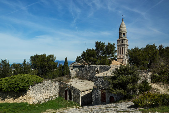 Old castle of the French Provence town of Orgon, located of the top of the cliff.