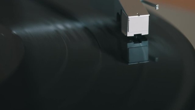 Record player stylus on a rotating disc