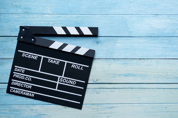 movie clapper on wood table ; film, cinema and vedio photography concept