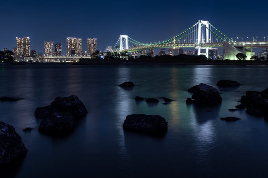 View to the Rainbow Bridge from Odaiba Shore at Night Tokyo Japan