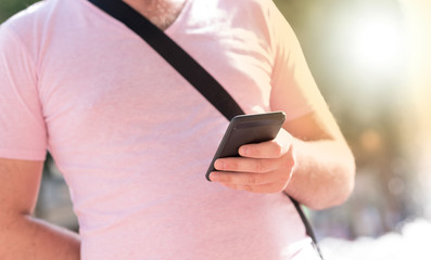 Man standing outside and using mobile phone, light effect